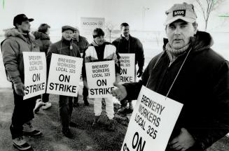 On the line: Union steward Derek Cunningham, right, and other members jump the gun and set up a picket line at the Molson brewery on Carlingview Dr. yesterday