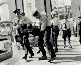 Police drag striker away after violent inglis clash (See page 21)