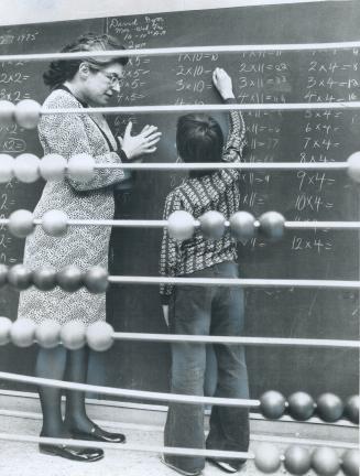 Special-Education teacher Caroline Jacques helps a boy with a learning disability through a multiplication drill
