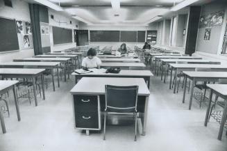 Without Teachers, three students at Georges Vannie Secondary School study on their own yesterday