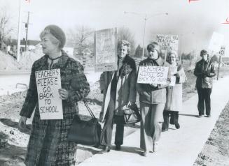Parents, above, picket against teachers' strike