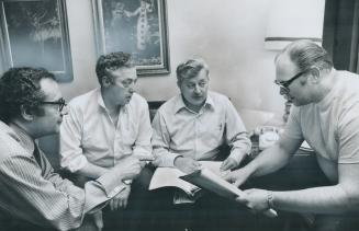 Weary officials of the Canadian Union of Public Employees huddle in their room at the Royal York late last night awaiting developments in negotiations(...)
