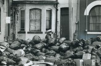 Mountain of garbage greats Michael Furiano, a security guard hired by the city to patrol a pile of garbage bags at Shuter and Seaton Sts. Furiano repr(...)