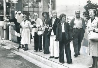 Santa Claus (erstwhile TV comic Gene Taylor) tries to brighten commuters' day as they look for rides at corner of Eglinton Ave. and Yonge St