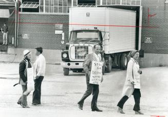 Members of Canadian Paperworkers Union Local 1284 walk the picket line outside Rolland Paper Co