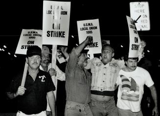 On the line: Stelco workers picket the company's Hamilton mill early this morning after contract negotiations for 15,400 steelworkers broke off