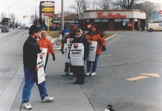 On the line: United Steelworkers organizers lead Tim Hortons employees on the picket line yesterday after negotiations failed at two outlets in London, Ont