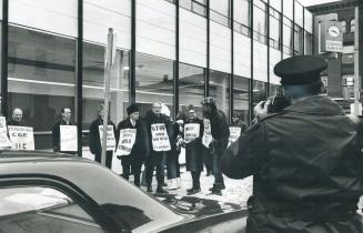 Police photograph New Democratic MPPs who joined picketing employees of Peterborough Examiner yesterday in support of their strike against the newspap(...)