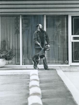 Security officer and Doberman Pinscher, He and his dog leave strikebound Kenroe Tool Ltd
