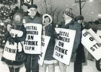 Postal workers picket, above, during recent mail disruption