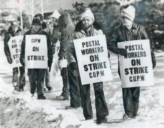 Inside workers, above, picket post office