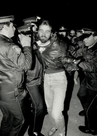 Gateway clash: Police officers surround and drag off a picket after a clash with Canadian Union of Postal Workers members at the Gateway sorting station in Mississauga
