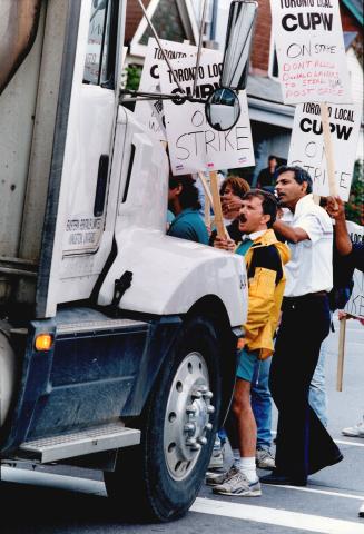 Angry posties: Pickets try to block a mall-loaded truck last month