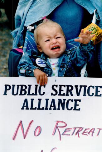 Crying Time: Alejandra Maltez, 18 months, grasps a sign as she joins mom Ramona Hall on a picket line in North York today