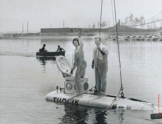 Ontario's first submarine launched, Mrs. Darcy McKeough, wife of the Ontario treasurer, tries out the six-ton observation submarine Tudlik - Eskimo fo(...)