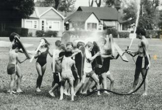 Summer camp is a blast - of cold water, Like ancient Roman legionnaires, these youngsters at the Island Canoe Camp on Toronto Islands use their paddle