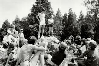 Open-air talk: Children gather round to listen to a counsellor at King View