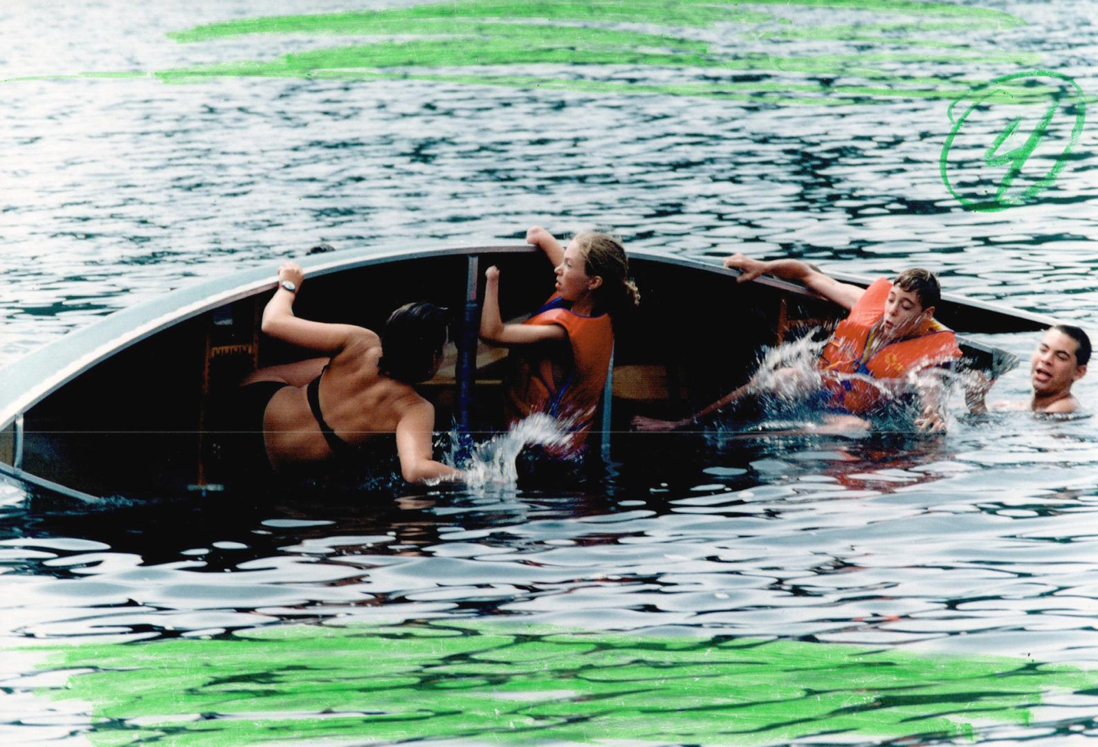 Getting wet: Dumping their canoe, just for fun, are counsellor Barb Prevedello, 25, Lisa Butler, 16, Jonathan Jones, 15, and Mike Mieczkowski, 14