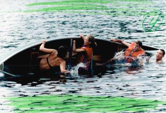 Getting wet: Dumping their canoe, just for fun, are counsellor Barb Prevedello, 25, Lisa Butler, 16, Jonathan Jones, 15, and Mike Mieczkowski, 14