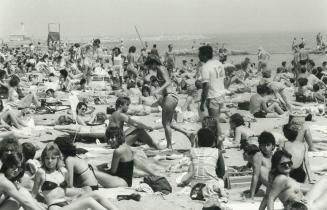 Hot stuff: While the sun's rays were beating down yesterday, swarms of sunbathers were beating it to Kew Beach to roast in as little clothing as the laws will allow