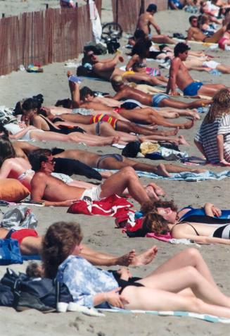 Woodbine beach was crowded yesterday as sun lovers worked on their tans in 23