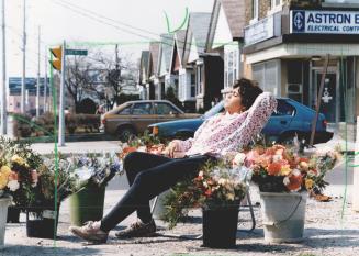 Sheila Stephens, 14, soaks up the sun while waiting for customers to buy her spring posies at the corner of Don Mills Rd, and O'Connor Drive in East Y(...)
