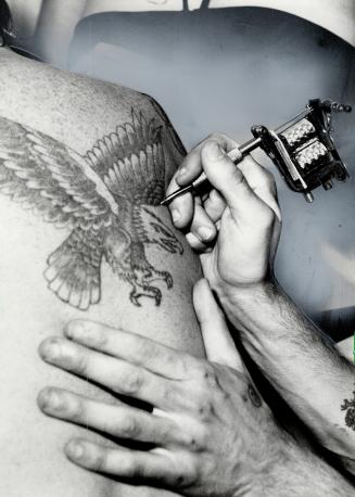 Fierce eagle is tattooed on client's back at Poppa Joe's Emporium in Oshawa