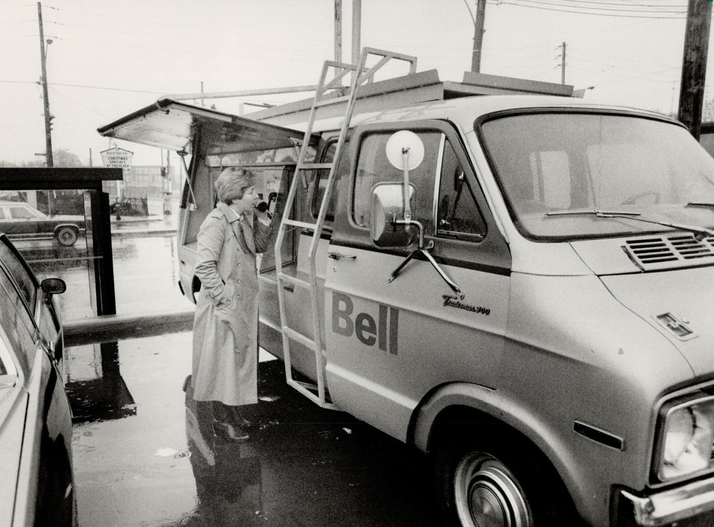 Free phones: Mary Clair Harrold of Laird Drive uses one of the emergency telephones set up in a Bell Telephone truck on a parking lot at Eglinton and Bayview Aves