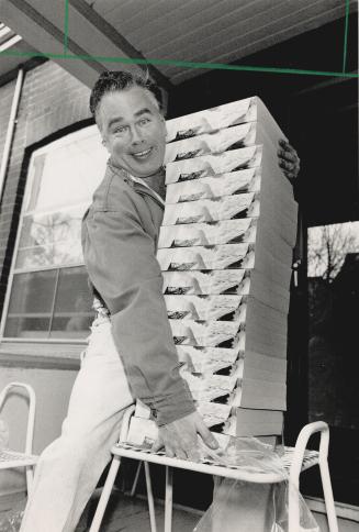 Pain in the back: Michael Burrell tries to lift some of the 17 telephone books he received