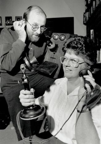On the line: Bob Somerset listens in while Ruth Burkholder holds a vintage office model phone