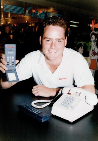 New hot line, Cantel's Adam Shearer displays his company's new cordless pocket phone alongside regular phones