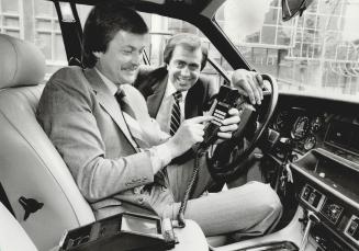 Portable chatter: Allan Nilsson, left, and Sheldon Kideckel of AMTS demonstrate their in-car phone