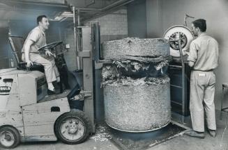 Nearly half a ton of leaf tobacco is weighed by Dave MacNeil (left) and Harry Dykxhoorn before entering the production line at Benson and Hedges plant(...)