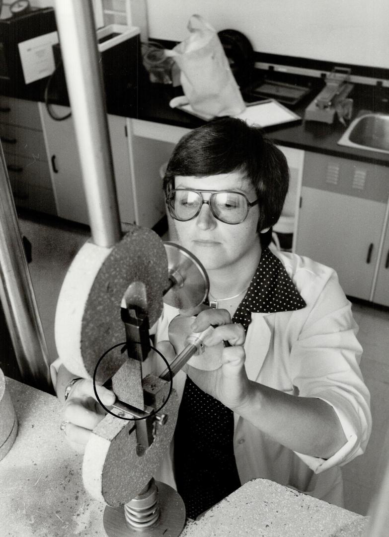 Tough test: Eva Muniak uses special machines in Eaton's product research lab to help take the guesswork out of buying children's wear by testing fabrics for durability, strength and comfort