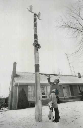 This Totem pole that John Regan and daughter Margaret are looking at was placed in his Don Mills yard by practical jokers while he was away in the U.S