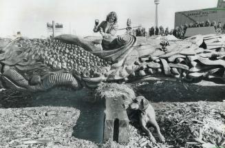 Real thanksgiving carving, Georganna Pearce Malloff puts the finishing touches to a huge red cedar totem pole she has been carving at Harbourfront all summer