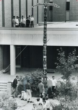 A Totem Pole Rises in Metro, As the students and staff of Woodbine Junior High School look on, 4 1/2 months of work are capped off as this totem pole is erected in front of the school