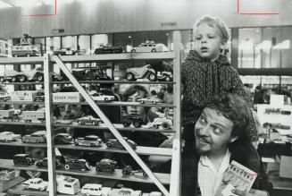 Felix Kristanovs, with son Stephen, 4, runs admiring eyes over Dinky Toy collection