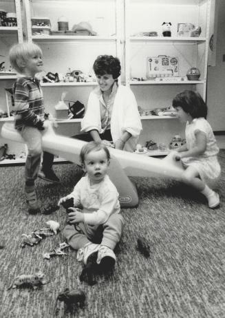 Toyland, toyland: Jillian Box, 18 months, Trevor Midwinter, 4, program co-ordinator Elaine Smith and Laura Delorey try out some toys in the Milton Toy Library