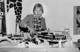 Put to the test: Toy store owner Lillian Starasts checks out a Brio wooden train set, one of the recommended playthings in the 1990 Toy Report