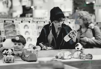 How many days left? Christmas shoppers look over the offerings in Eaton's toy department