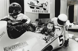 Eleven-year-old Danlela Syrovy of Thornhill joins two mannequins yesterday at Exhibition Place for a long, low look from the racing sidecar Thunder 'n(...)