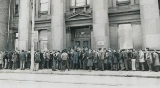 Unemployed men line up at the Metro welfare office on Adelaide St