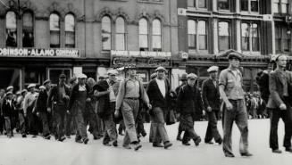 Relief strikers gather at Winnipeg. Camp strikers are seen at LEFT as they marched through the streets of the city.