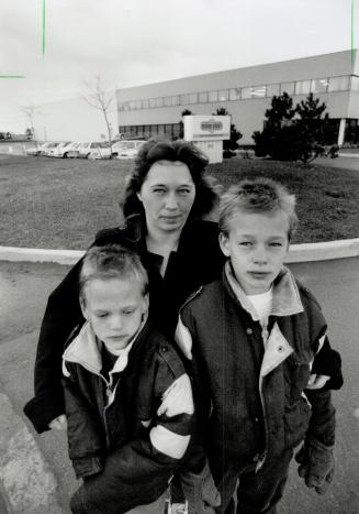 Bleak uule: Sue Lehmann stands with sons Sean, 9, left, and Darryl, 11, at the Easy Plan plant yesterday