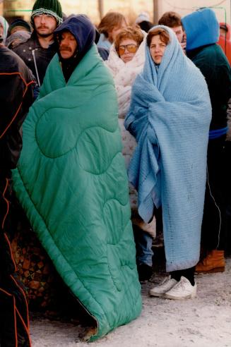 Nicole Lebarge of Port Hope, rear centre, and Michele Roemer of Cobourg, in blue blanket, lined up for GM application at 3:30 a.m. yesterday