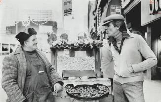 Popcorn vendor on Yonge St. is impressed by the model's dynamite look in casual wear. He is wearing a velvet blouson jacket with side slash pockets wh(...)
