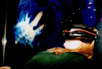 Dollars & sense: Zilla Parker tries out the Sensory Experience chair at the newly launched Cybermind Cafe, 257 Yonge St