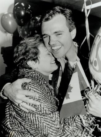 Glad to be back: Fighter pilot Emile Calderon gets a big hug from his mother, Eileen, at Pearson Airport last night on his return home from the gulf