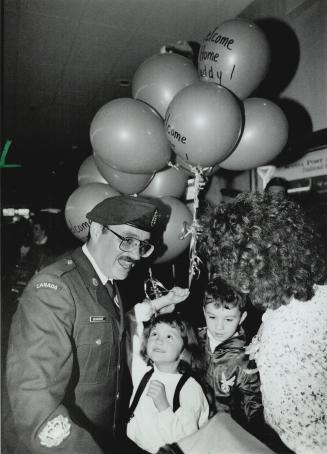 Daddy's home: Monique Beauchamp, 7, greets her father Maurice, above, with balloons as he returns home with other crew from HMCS Protecteur after several months' duty in the Persian Gulf